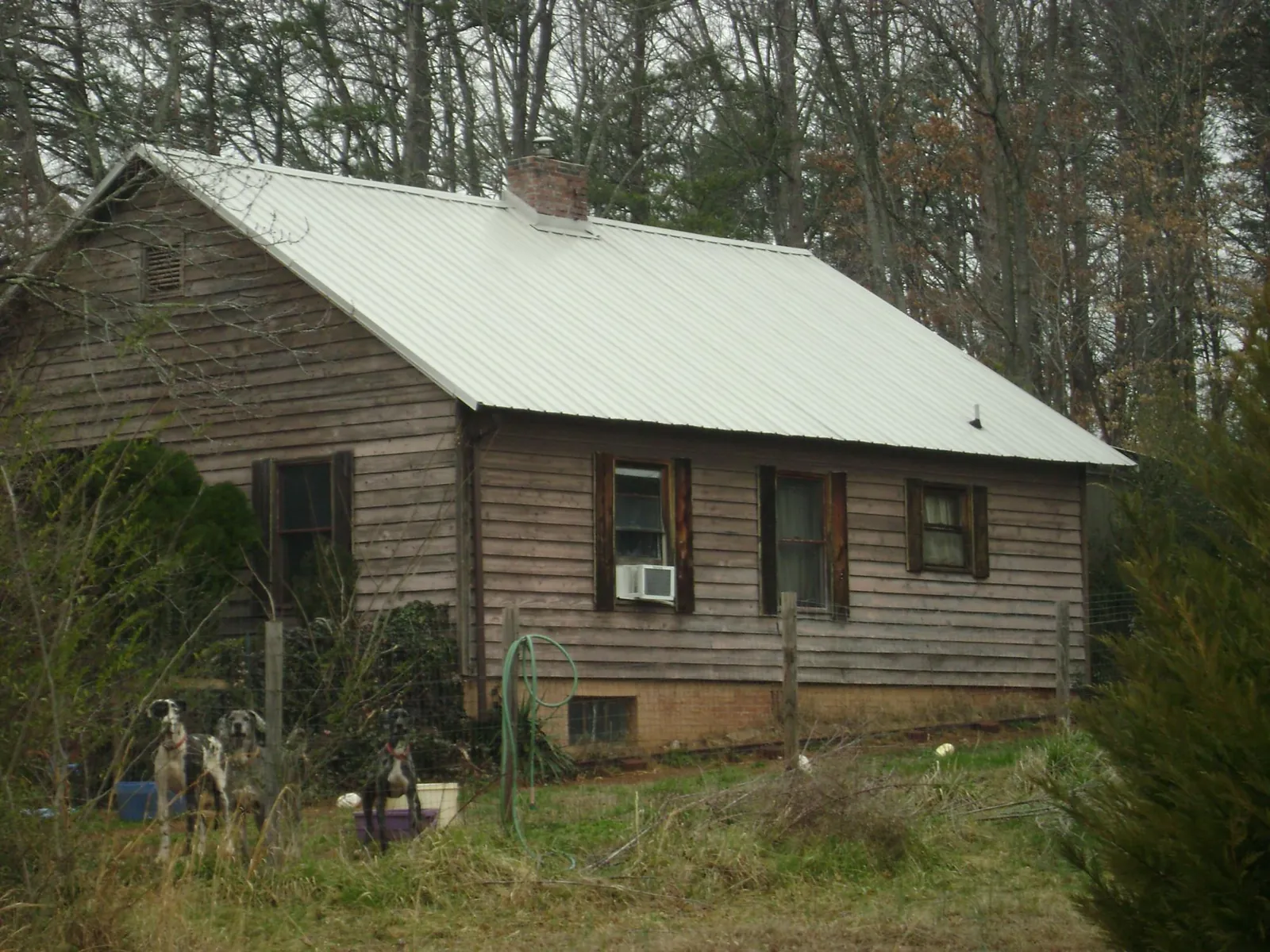 White metal roof on an old wood sided farmhouse, from a Metal Roof Installation job in Blain